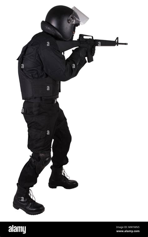 SWAT officer with assault rifle in black uniform isolated on white ...