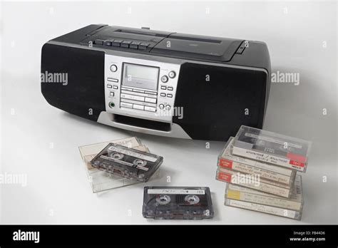 Home Recorded Cassette Tapes Stacked Up In Front Of A 1990s Style Cassette Radio And And Cd