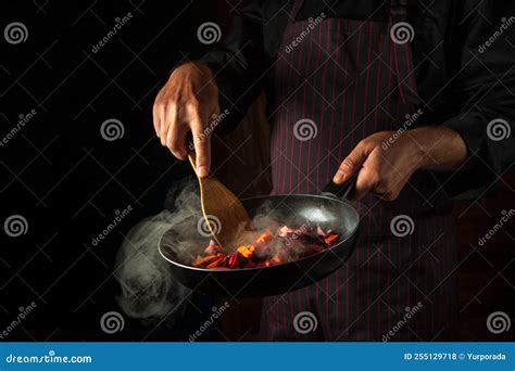 Cooking Vegetables On A Hot Frying Pan In The Hands Of A Chef