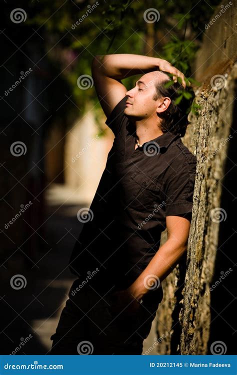 Man With Raised Hand Leans Wall In The Street Stock Image Image Of