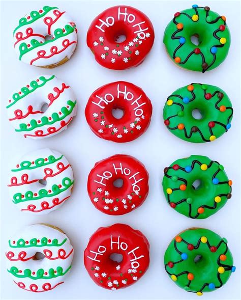 Twelve Decorated Donuts With Happy Holidays Written On The Top And