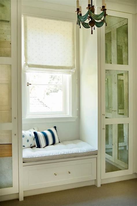 Closet With Built In Window Seat Flanked By Mirrored Cabinets