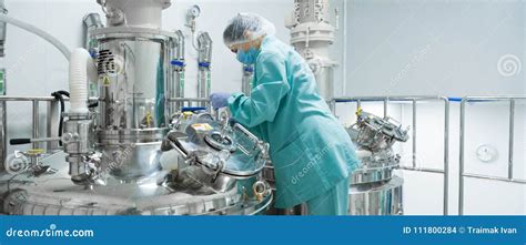 Pharmaceutical Factory Woman Worker In Protective Clothing Operating