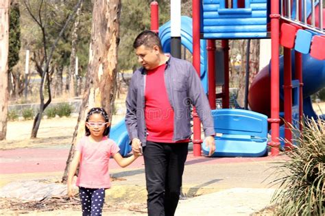 Single Dad Walks Through The Park With His 5 Year Old Latina Daughter