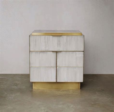 a white and gold dresser sitting on top of a cement floor