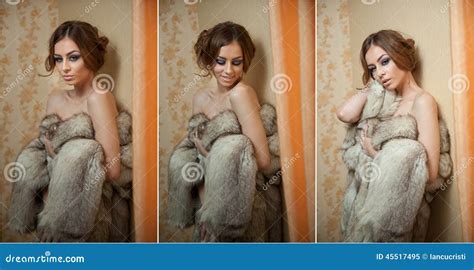 Attractive Young Woman Wearing A Fur Coat Posing Provocatively Indoor