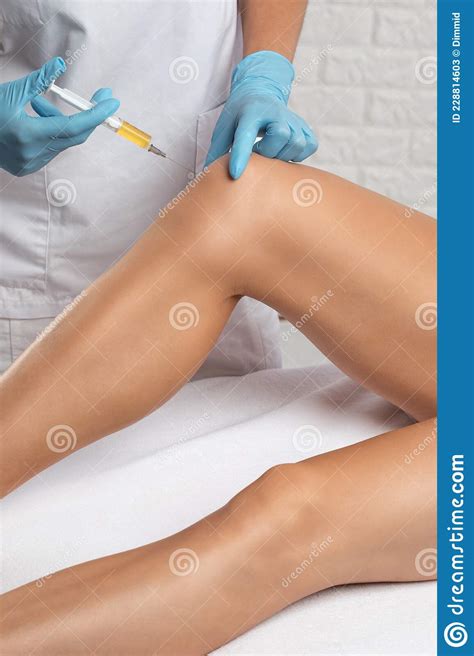 Doctor Doing Stem Cell Therapy On A Patient`s Knee After The Injury