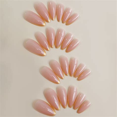 Chic Nude Stiletto Nails with Gold Tips Stylö