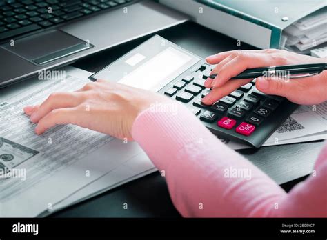 Female Accountant In Office Draws Up Annual Report Using Income Table