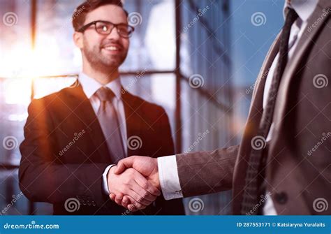 Two Businessmen Shaking Hands and Making a Deal in an Office Corridor ...