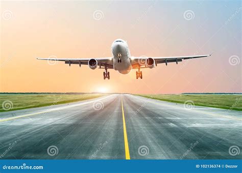 The Plane Landed On The Runway In The Evening At Sunset At The Airport