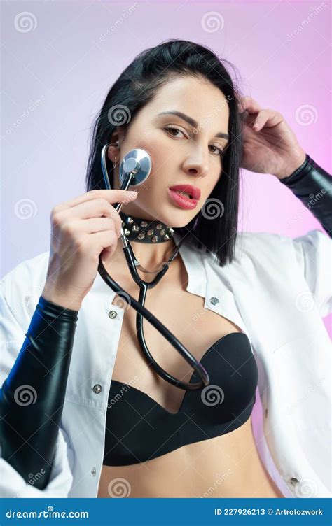 Portrait Of A Female Doctor In Underwear And A White Coat With A Medical Stethoscope Stock Image