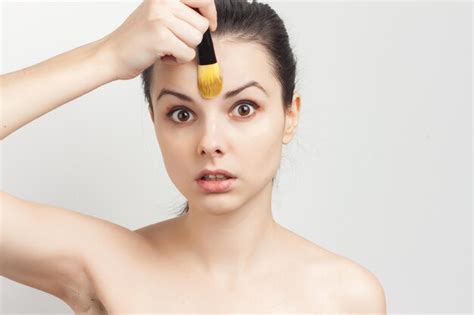 Premium Photo Brunette Naked Shoulders Brush In Hands Applying Cream Person