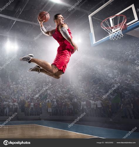 Basketball player makes slam dunk Stock Photo by ©alexkravtsov 168325592