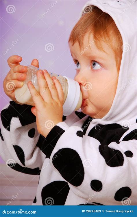 Baby in Cow Costume Drinking Milk from Bottle Stock Image - Image of ...