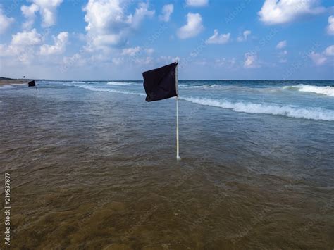 Black Flag on the sea shore-warning about dangerous current and waves ...