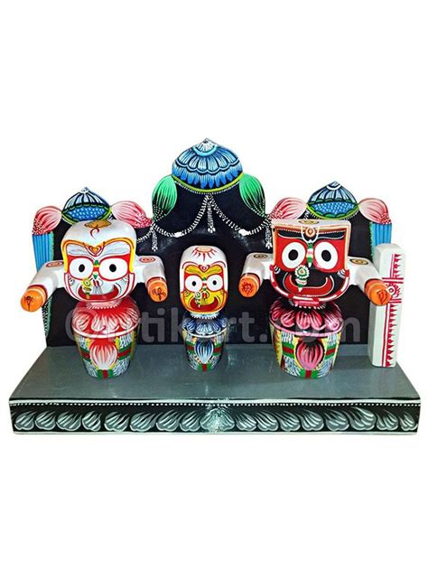 Three Colorful Figurines Sitting On Top Of A Black Stand With An Ornate