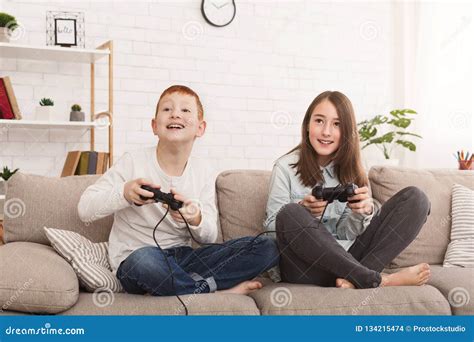 Friendly Brother and Sister Playing Video Games Together Stock Photo ...