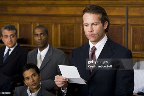 Juror Standing In A Jury Box And Reading The Verdict High Res Stock