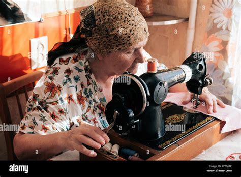 Grandma Sewing On Vintage Sewing Machine Her Hands Pushing Pink Fabric