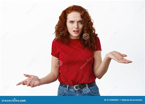 Annoyed And Confused Female Redhead Model With Curly Hair Shrugging