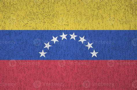 Venezuela flag depicted in bright paint colors on old relief plastering
