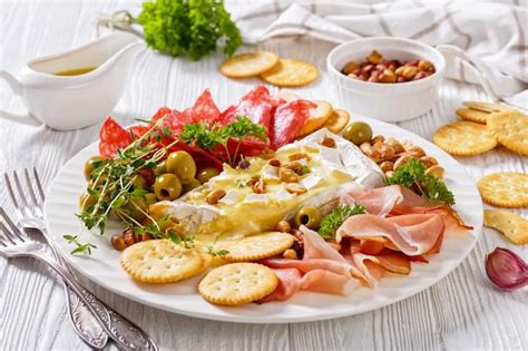 Premium Photo Savory Baked Brie With Crackers Salami Nuts Ham