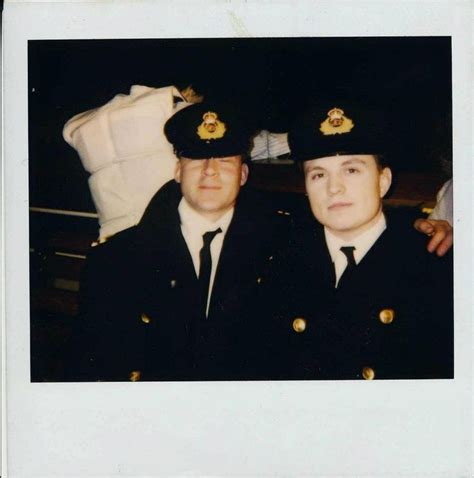 two men in uniform posing for a photo