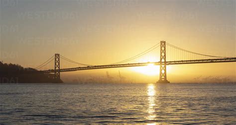 Sunrise behind Oakland Bay Bridge at San Francisco, California, USA ...