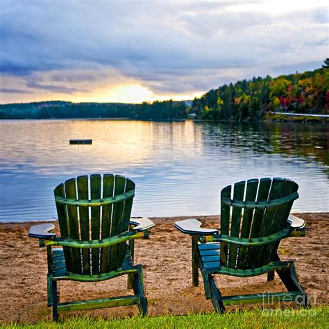 Wooden chairs at sunset on beach Photograph by Elena Elisseeva