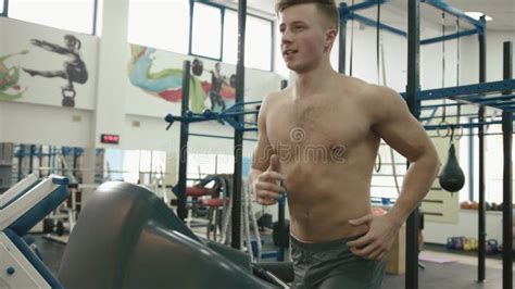 Sportive Muscular Man With Naked Torso Warming Up On The Treadmill At Modern Gym 4k Footage