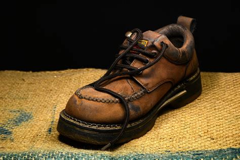 Brown and Black Leather Work Boots on Brown Surface · Free Stock Photo