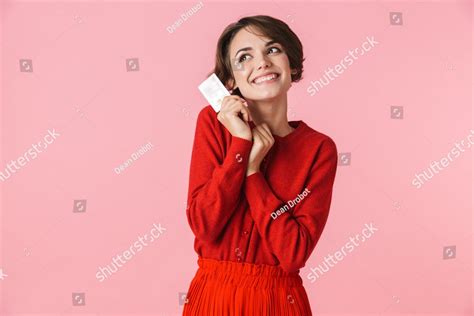 Portrait Of A Beautiful Young Woman Wearing Red Clothes Standing