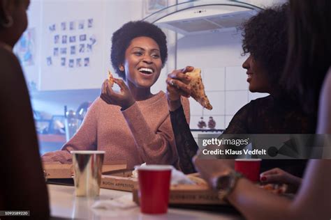 Young Women Having Party In The Kitchen And Eating Pizza High Res Stock