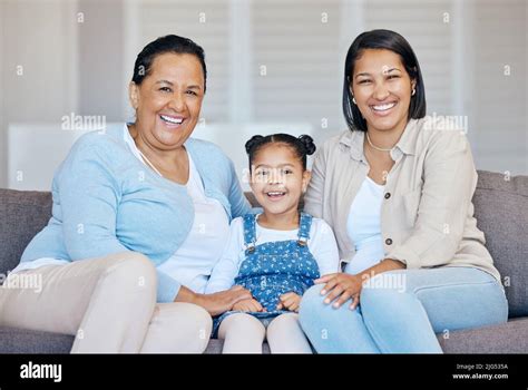 Happy Mature Grandmother Relaxing With Her Granddaughter And Adult Daughter At Home Cheerful