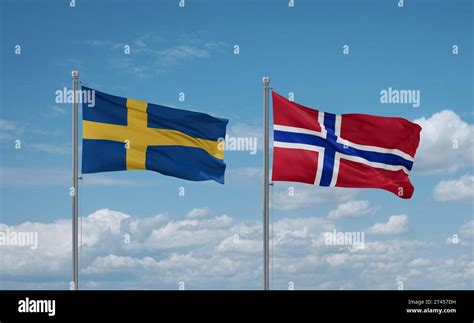 Norway and Sweden flags waving together on blue cloudy sky, two country relationship concept ...