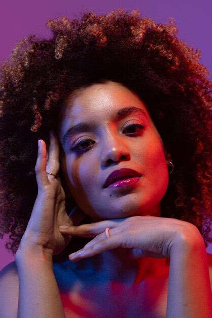 Premium Photo Biracial Woman With Curly Hair Touching Face In Red And