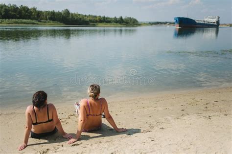 Dos Muchachas Que Toman El Sol En La Playa Meridional De Tromso