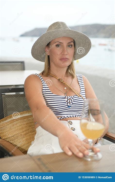 Portrait Of A Woman Sitting Next To The Sea And Looking At The Camera Stock Image Image Of