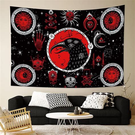 a living room with a black couch and red wall hanging on the wall above it