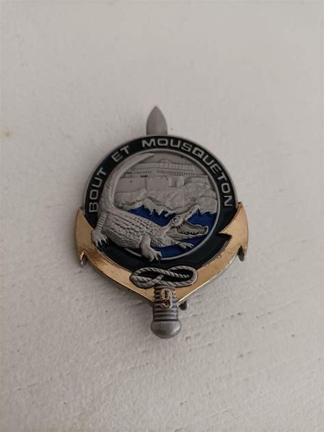 The Badge Is Hanging On The Wall In Front Of A White Wall With A Black