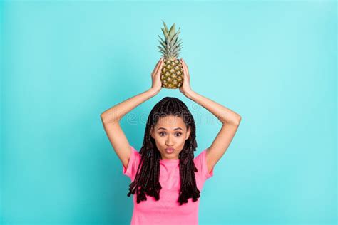 Photo Of Affectionate Girl Hold Pineapple Raise Hands Blow Air Kiss