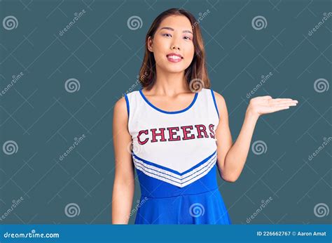 Young Beautiful Chinese Girl Wearing Cheerleader Uniform Smiling