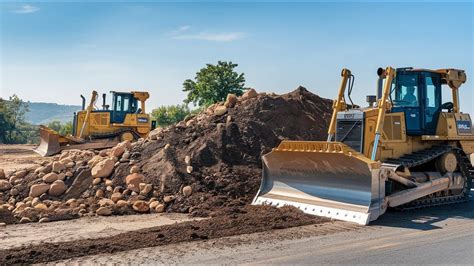 The Bulldozers Push A Large Pile Of Dirt A New Road Construction Site