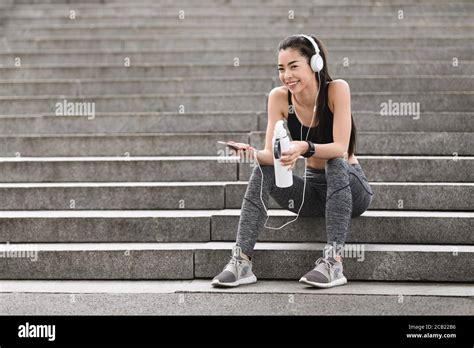 After Successful Training Sporty Girl Resting On Urban Stairs After