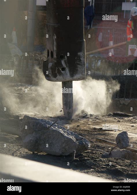 Breaking Up Concrete Road Surface With A Pneumatic Hammer Lots Of Dust