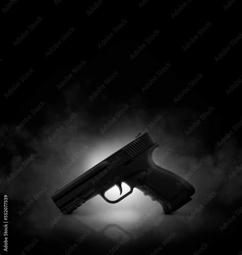 Chrome gun on black background with smoke Stock Photo | Adobe Stock