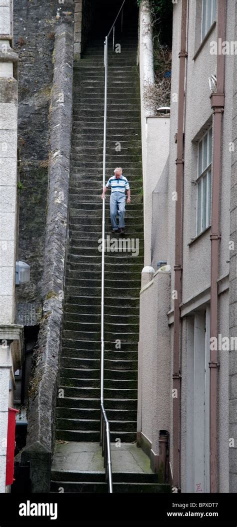 A Man Walks Down The Jacobs Ladder Steps In Falmouth Cornwall Stock