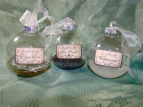 Three Glass Christmas Ornaments With Labels On Them