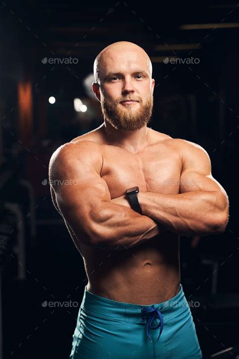 A Man Posing For The Camera With His Arms Crossed In Front Of Him